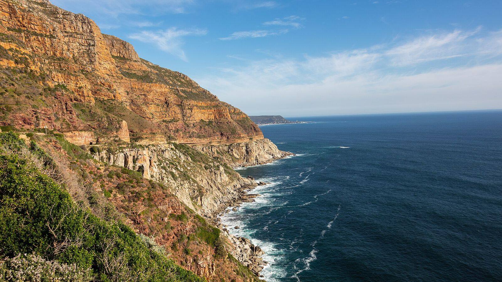 Auto op de kronkelende kustweg Chapman's Peak Drive boven de oceaan bij Kaapstad